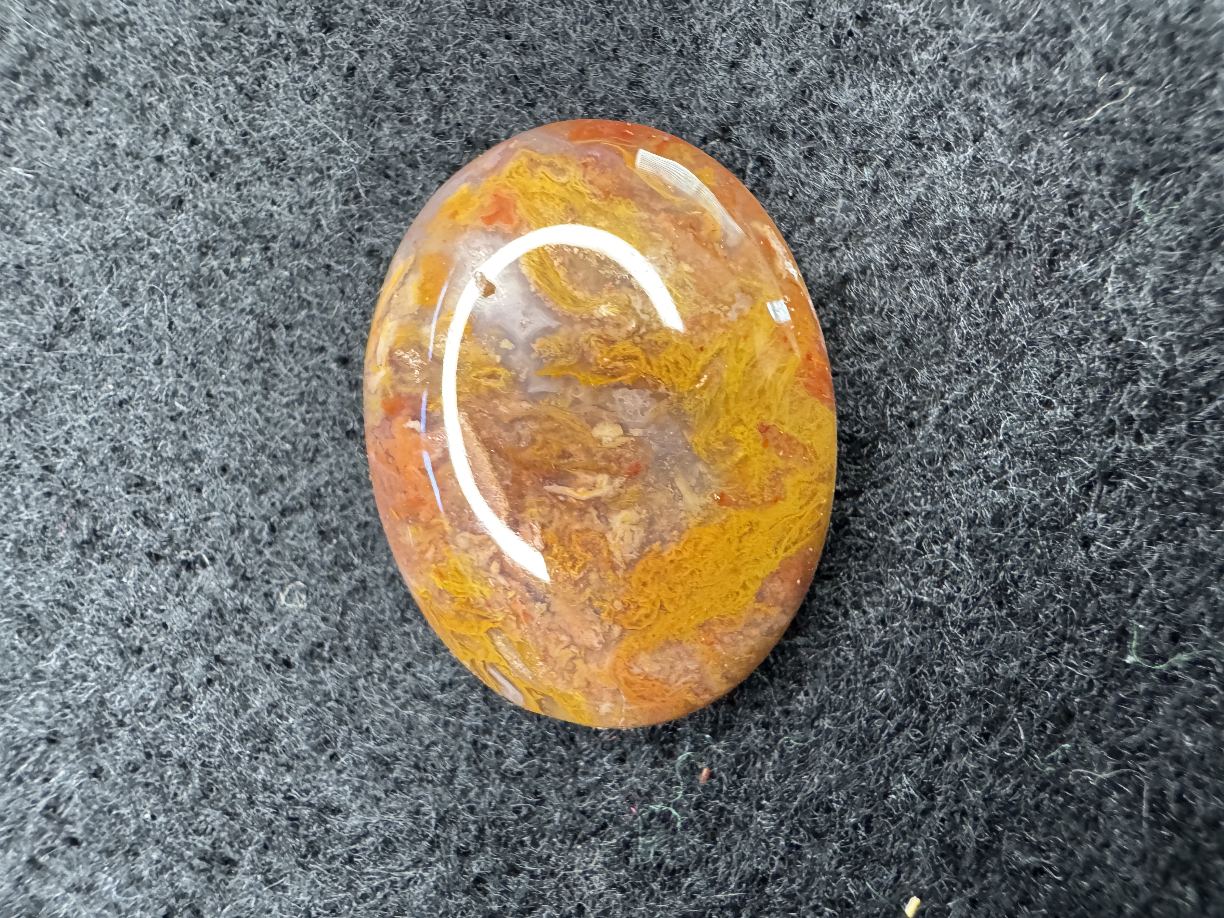 Bright orange, yellow and peach moss agate showcasing intricate mossy patterns.