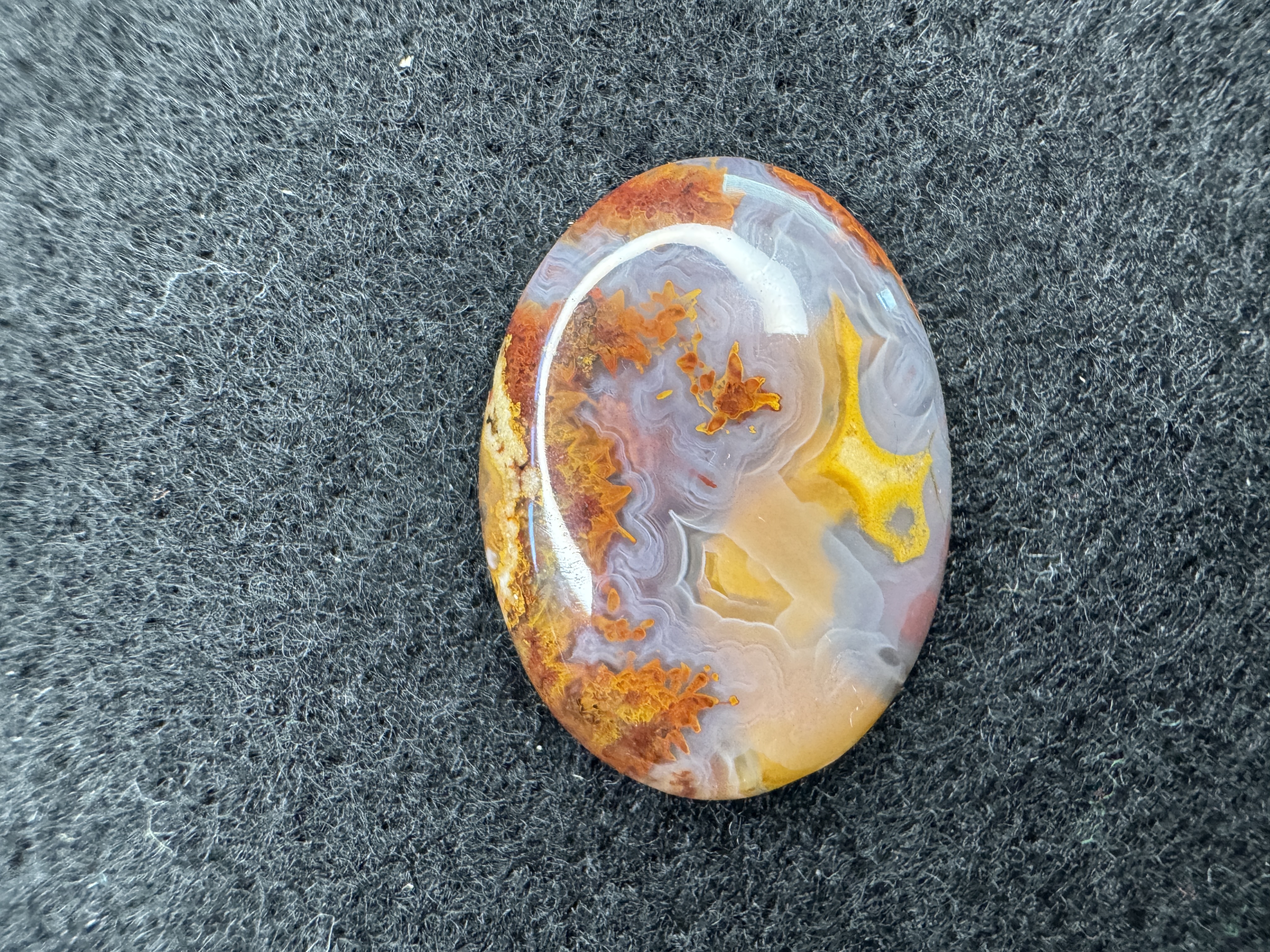 Arizona Agate cabochon with yellow patterns and multi-level banding details. Polished gemstone for jewelry making and collectors.