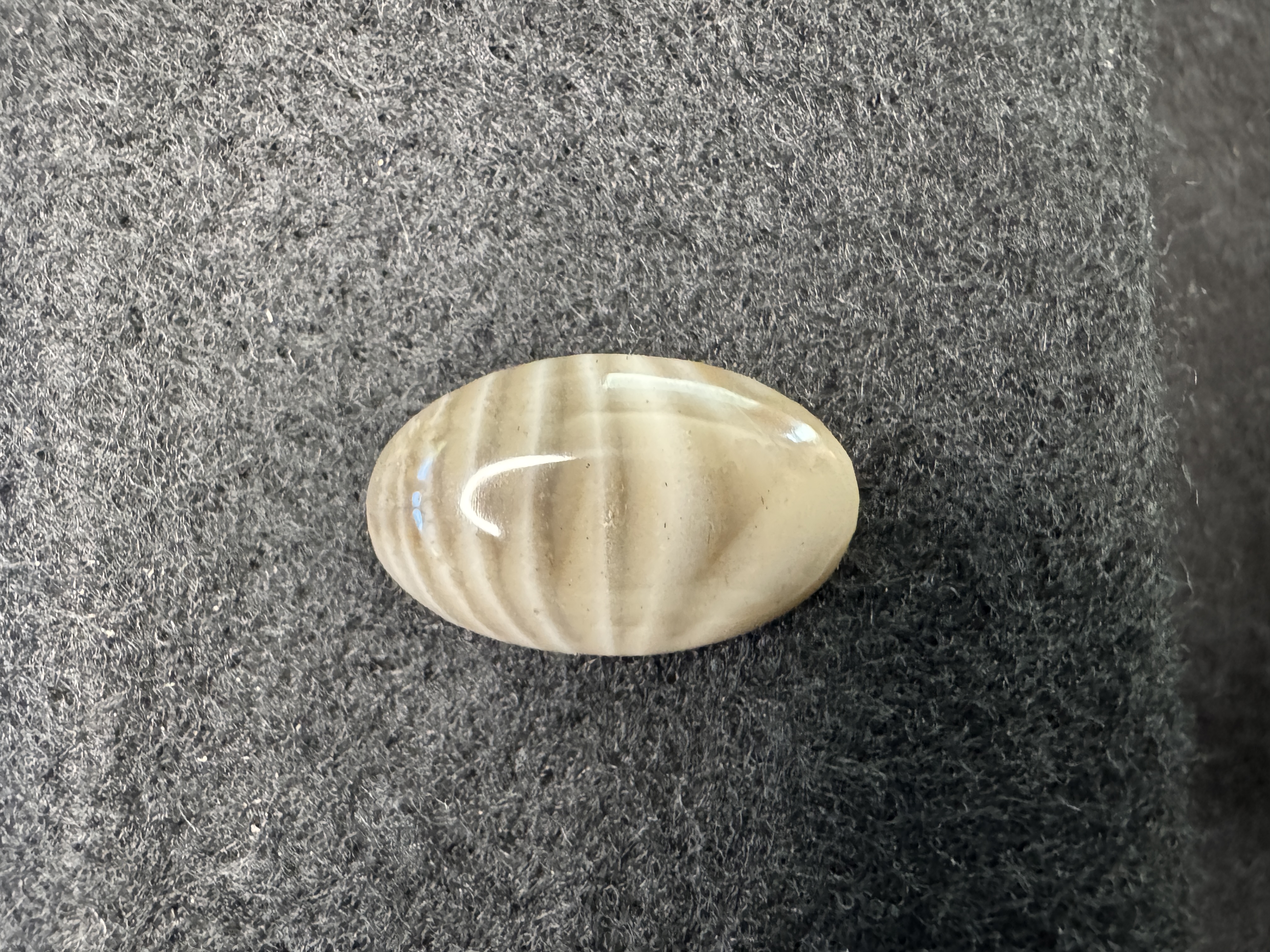 Banded Chert cabochon with distinct layers and patterns. Polished gemstone for jewelry making and collectors.