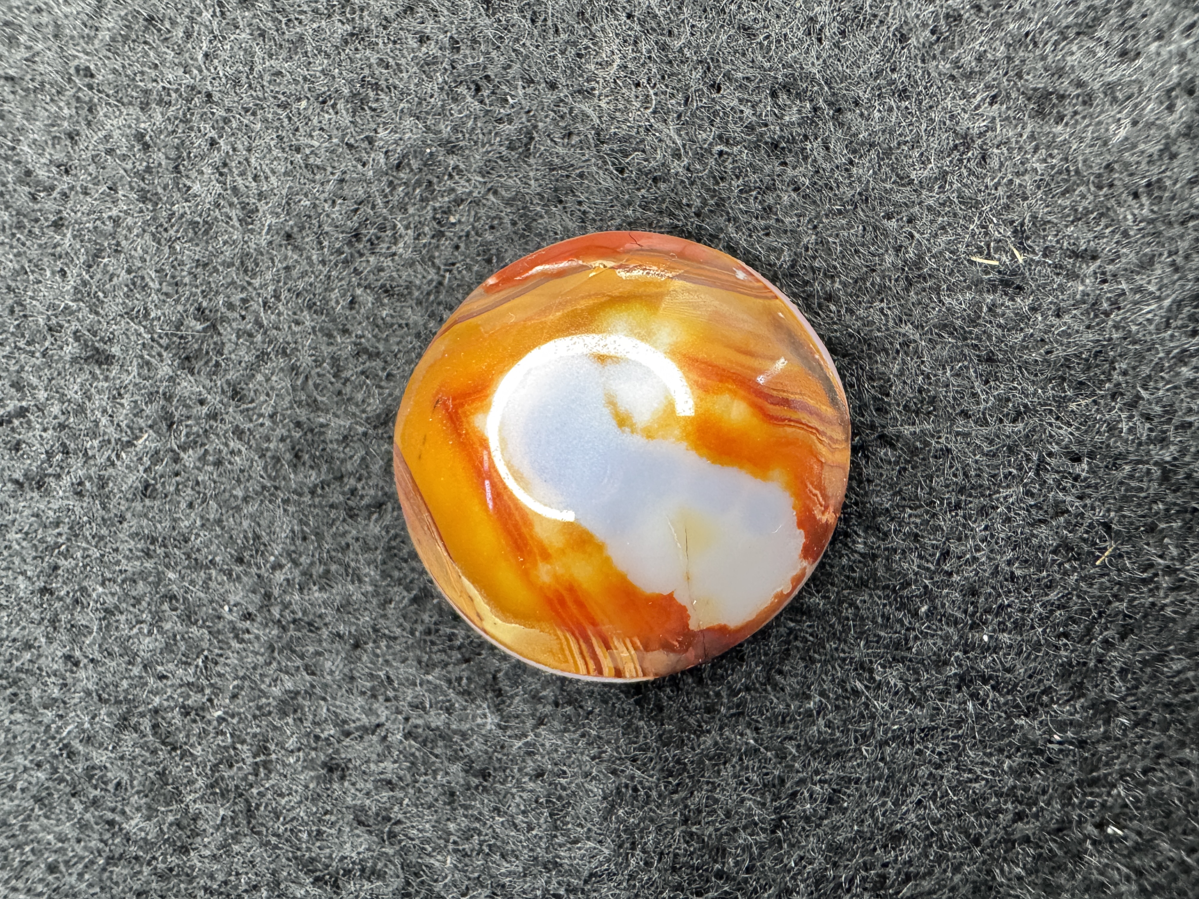 Polished lace agate eye cabochon with exquisite, detailed banding patterns.