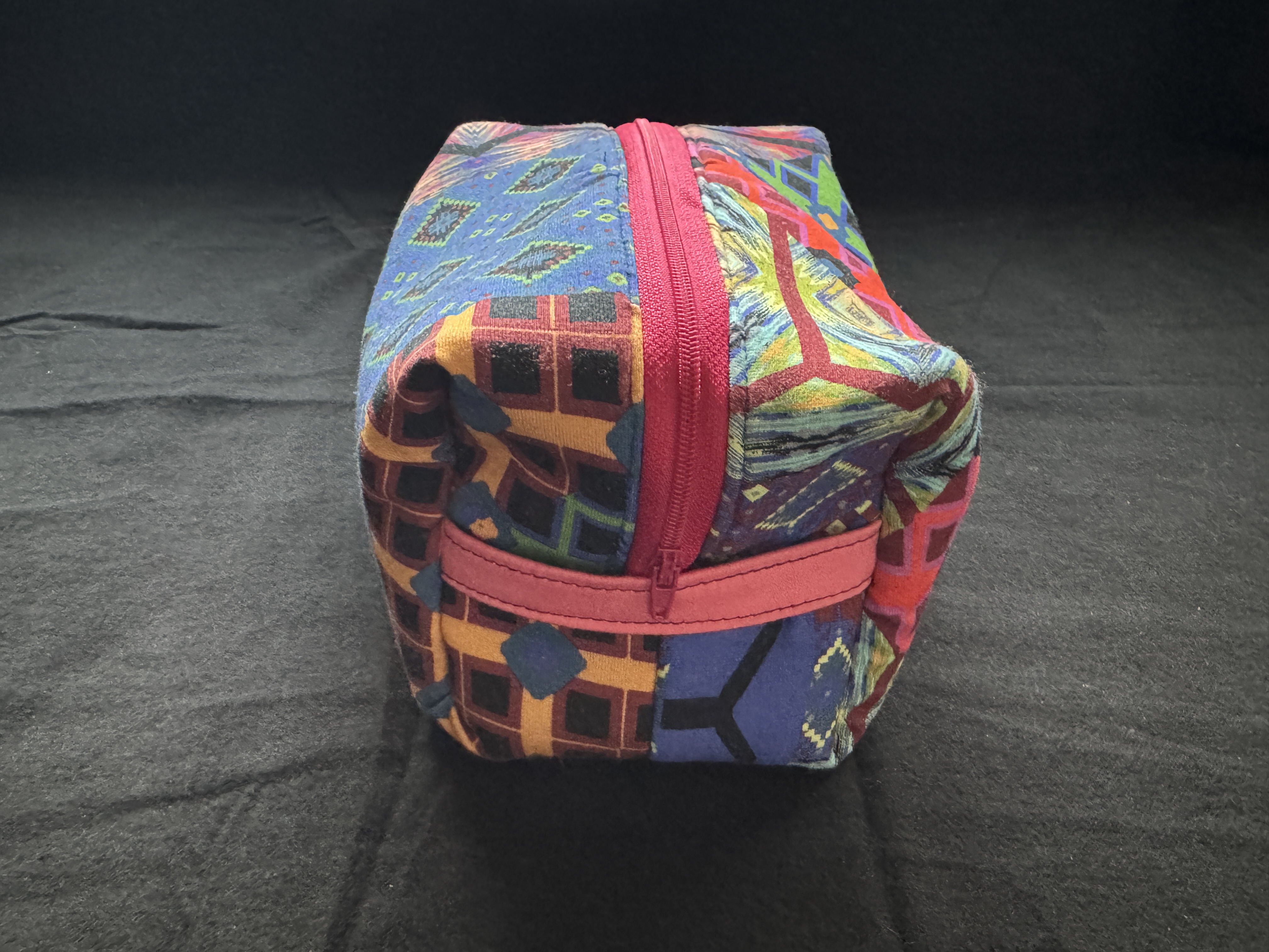 Handcrafted cosmetics organizer side handle placement