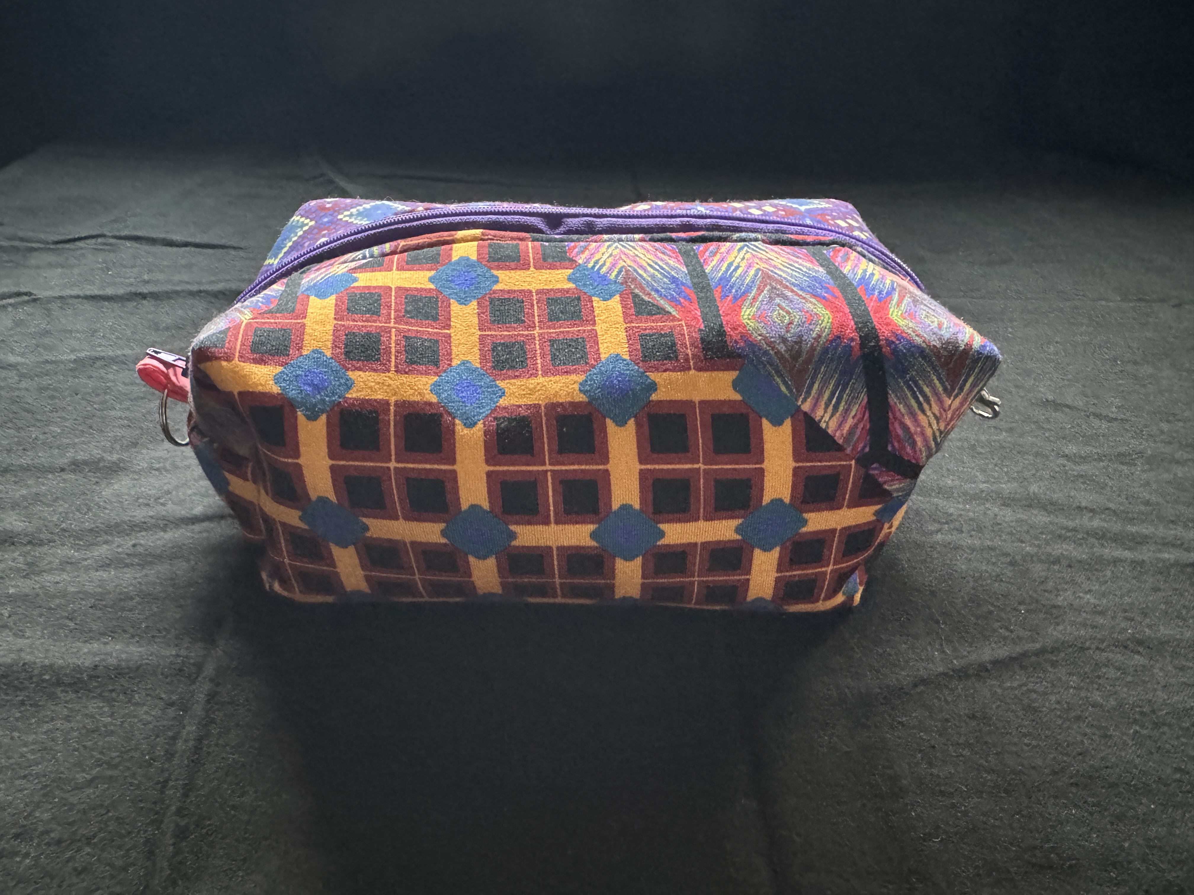 Purple quilted cosmetic pouch clawhook side detail