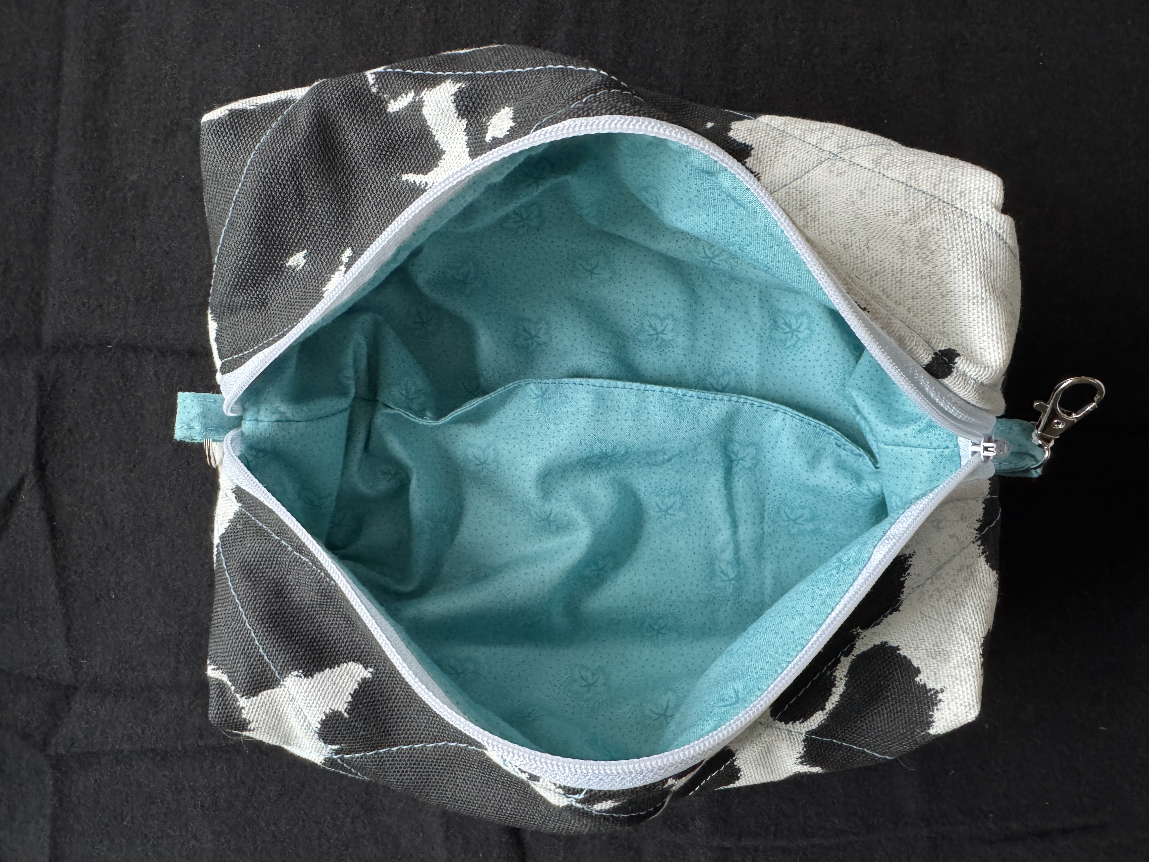 Turquoise accent stitching and clawhook connector details